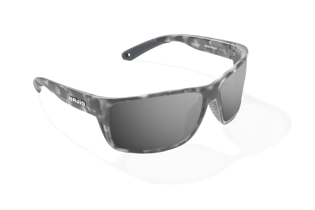 Angled view of Gray Rock Matte Bales Beach Bajio tech angler sunglasses, bio-based nylon frames with gray polarized lenses, full wrap, large fit, premium built in sun ledge and pin hinges, ideal for fishing and outdoor use.