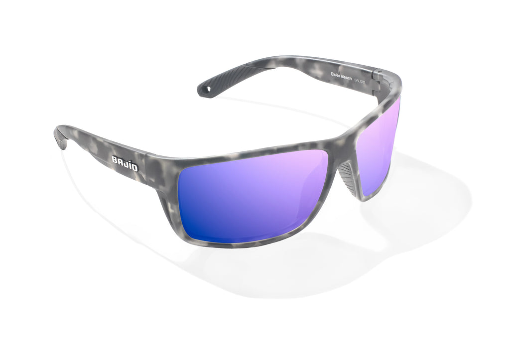 Angled view of Gray Rock Matte Bales Beach Bajio tech angler sunglasses, bio-based nylon frames with violet mirror polarized lenses, full wrap, large fit, premium built in sun ledge and pin hinges, ideal for fishing and outdoor use.