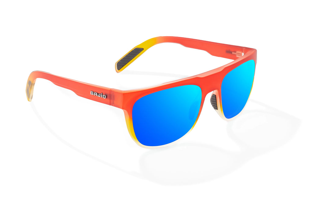 Angled view of Red Yellow Sky Matte Chelem Bajio surf sunglasses, bio-based nylon frames with blue mirror polarized lenses, medium wrap, medium fit, premium built in sun ledge and flex hinges, ideal for fishing and outdoor use.