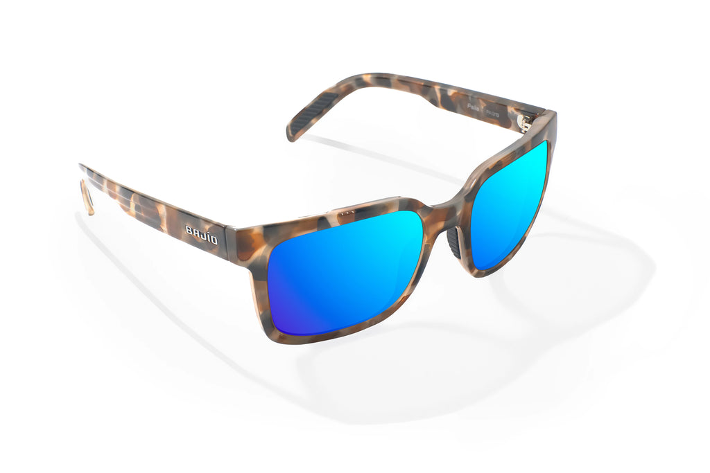 Angled view of Tan Rock Gloss Paila Bajio beach sunglasses, bio-based nylon frames with blue mirror polarized lenses, extra large fit premium, built in sun ledge and sturdy barrel hinges, ideal for fishing and outdoor use.