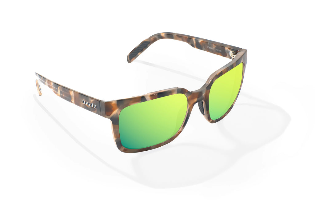 Angled view of Tan Rock Gloss Paila Bajio beach sunglasses, bio-based nylon frames with green mirror polarized lenses, extra large fit premium, built in sun ledge and sturdy barrel hinges, ideal for fishing and outdoor use.