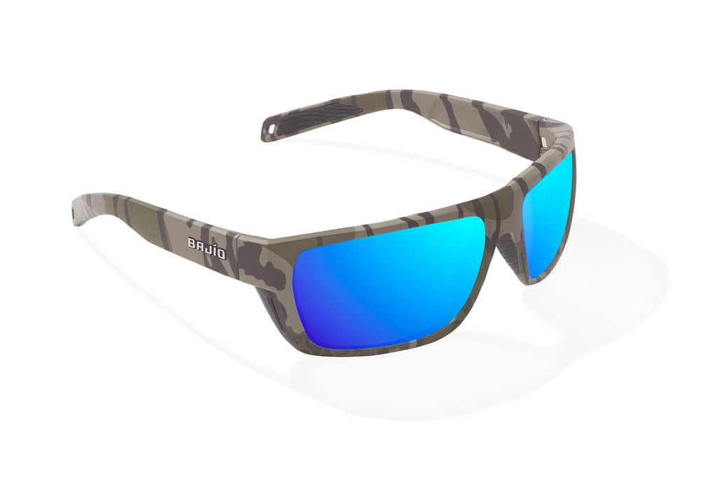 Angled view of Army Green Bottomlands Palometa in collaboration with Mossy Oak x Bajio tech angler sunglasses, bio-based nylon frames with blue mirror polarized lenses, full wrap, medium fit, premium built in sun ledge and flex hinges, ideal for fishing and outdoor use.