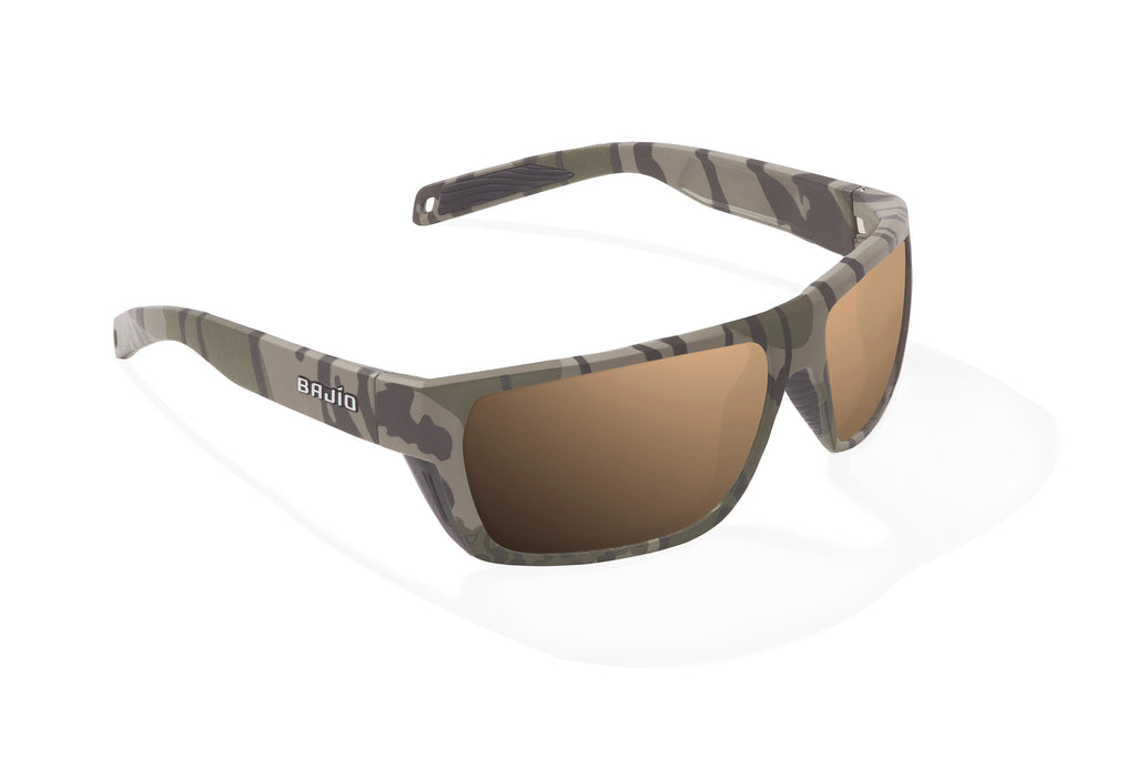 Angled view of Army Green Bottomlands Palometa in collaboration with Mossy Oak x Bajio tech angler sunglasses, bio-based nylon frames with copper polarized lenses, full wrap, medium fit, premium built in sun ledge and flex hinges, ideal for fishing and outdoor use.