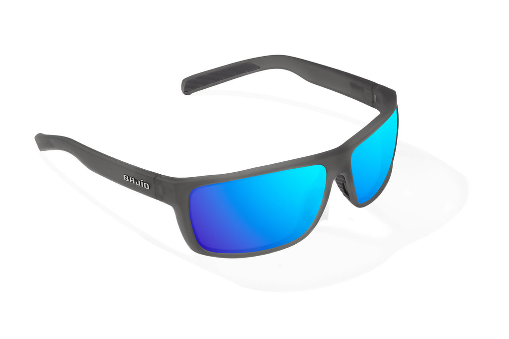 Angled view of Dark Gray Glass Matte Sigs Bajio tight line sunglasses, bio-based nylon frames with blue mirror polarized lenses, full wrap, medium fit, premium built in sun ledge and flex hinges, ideal for fishing and outdoor use.