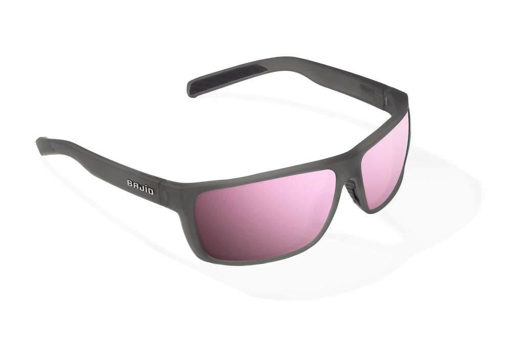 Angled view of Dark Gray Glass Matte Sigs Bajio tight line sunglasses, bio-based nylon frames with rose mirror polarized lenses, full wrap, medium fit, premium built in sun ledge and flex hinges, ideal for fishing and outdoor use.