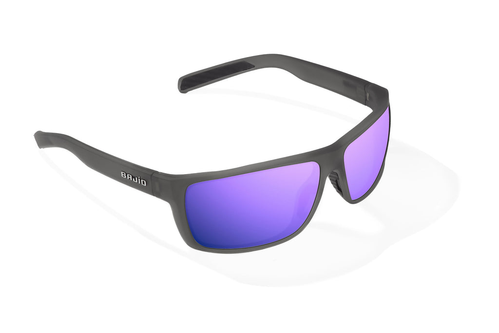 Angled view of Dark Gray Glass Matte Sigs Bajio tight line sunglasses, bio-based nylon frames with violet mirror polarized lenses, full wrap, medium fit, premium built in sun ledge and flex hinges, ideal for fishing and outdoor use.