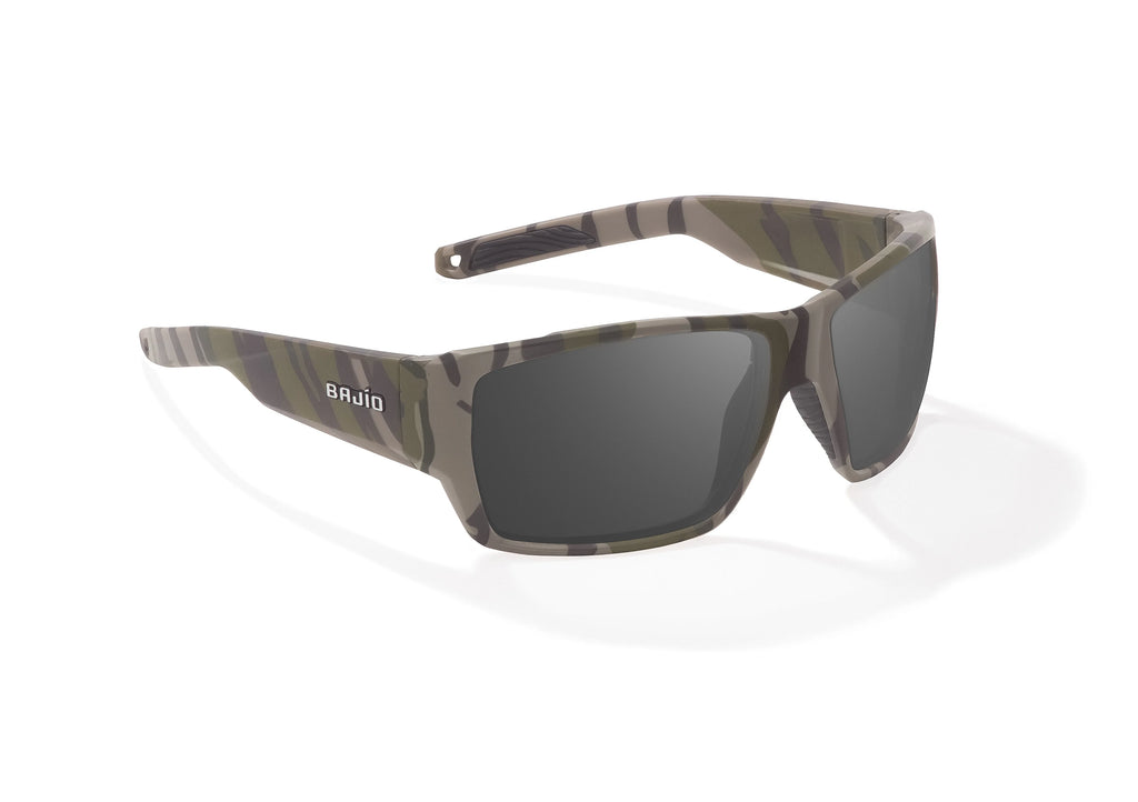 Angled view of Army Green Bottomlands Vega in collaboration with Mossy Oak x Bajio wide body sunglasses, bio-based nylon frames with gray polarized lenses, full wrap, large fit, premium built in sun ledge and flex hinges, ideal for fishing and outdoor use.