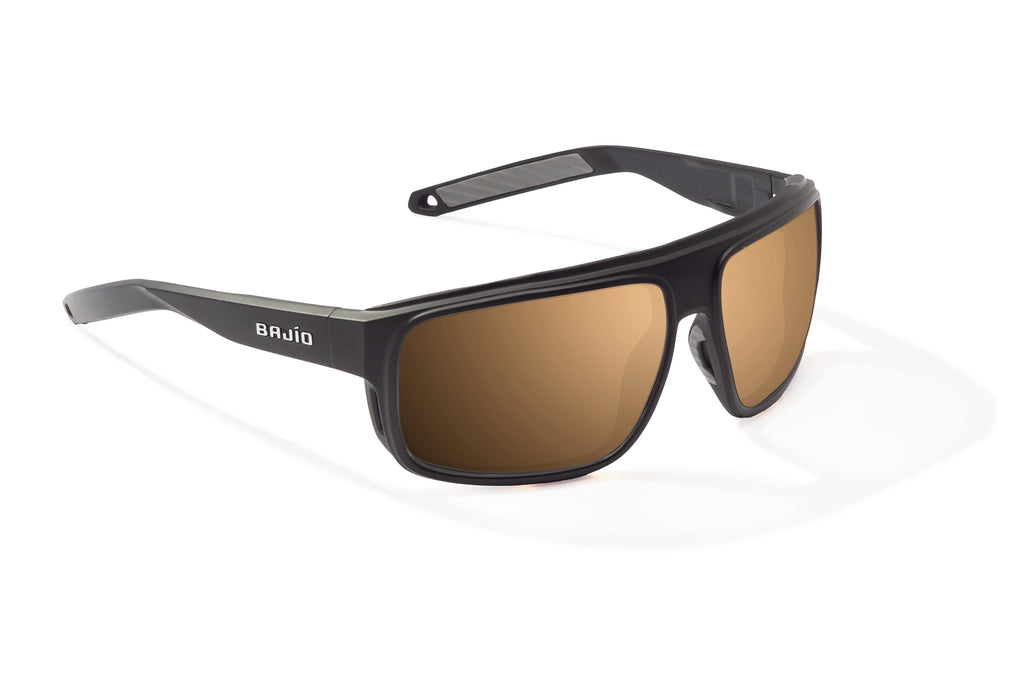 Angled view of Black Matte Greenland Bajio tech angler sunglasses, bio-based nylon frames with copper polarized lenses, full wrap, large fit, premium built in sun ledge and flex hinges, ideal for fishing and outdoor use.