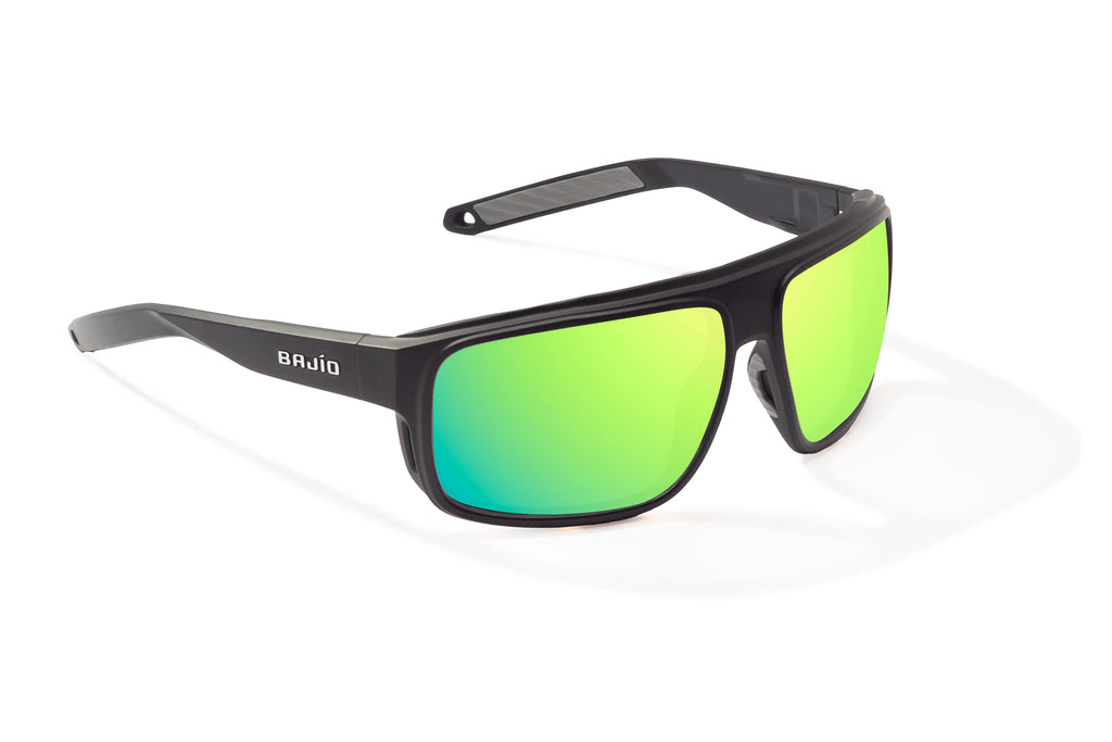 Angled view of Black Matte Greenland Bajio tech angler sunglasses, bio-based nylon frames with green mirror polarized lenses, full wrap, large fit, premium built in sun ledge and flex hinges, ideal for fishing and outdoor use.