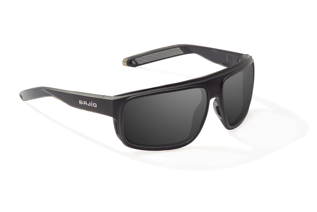 Angled view of Black Matte Greenland Bajio tech angler sunglasses, bio-based nylon frames with gray polarized lenses, full wrap, large fit, premium built in sun ledge and flex hinges, ideal for fishing and outdoor use.