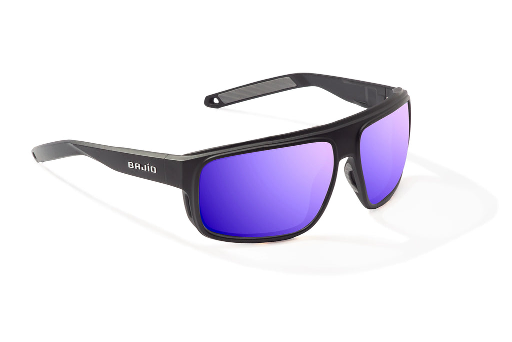 Angled view of Black Matte Greenland Bajio tech angler sunglasses, bio-based nylon frames with violet mirror polarized lenses, full wrap, large fit, premium built in sun ledge and flex hinges, ideal for fishing and outdoor use.